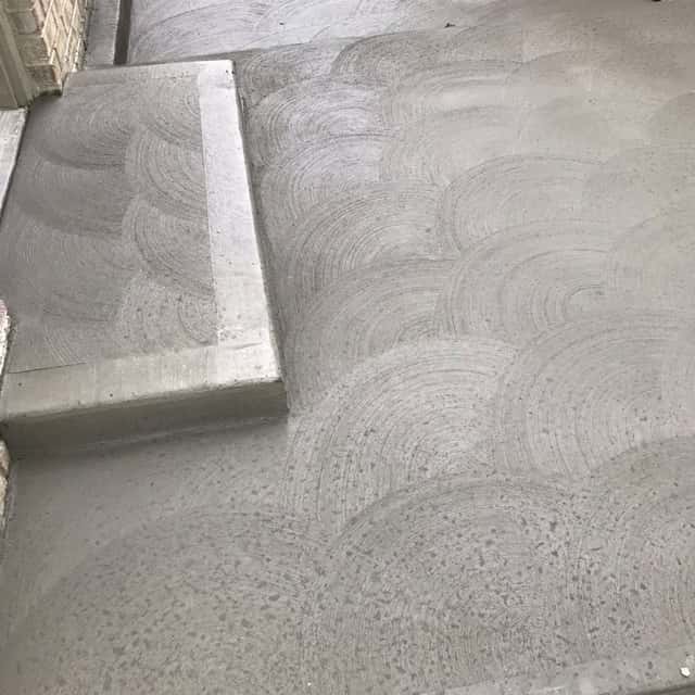 Swirl-finished concrete patio with a raised step, freshly poured — JFC Concrete LLC, Indianapolis, IN