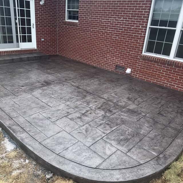 Stamped and bordered concrete patio behind a brick home — JFC Concrete LLC, Indianapolis, IN