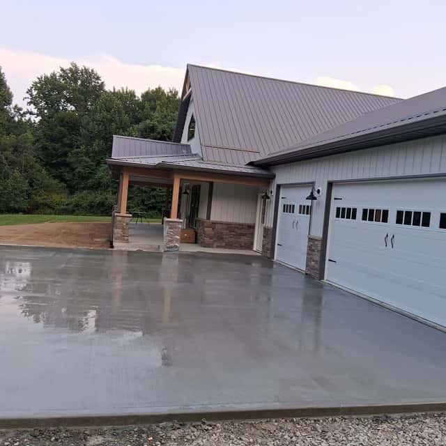 New concrete driveway and apron in front of a three-car garage — JFC Concrete LLC, Indianapolis, IN